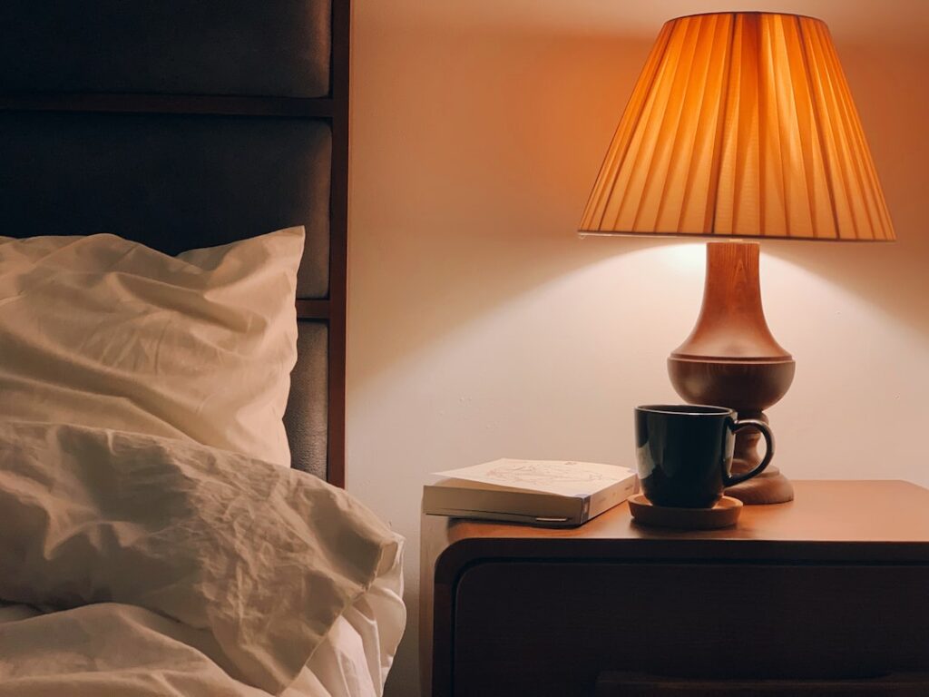Warm bedside lamp creating a calm evening bedroom atmosphere