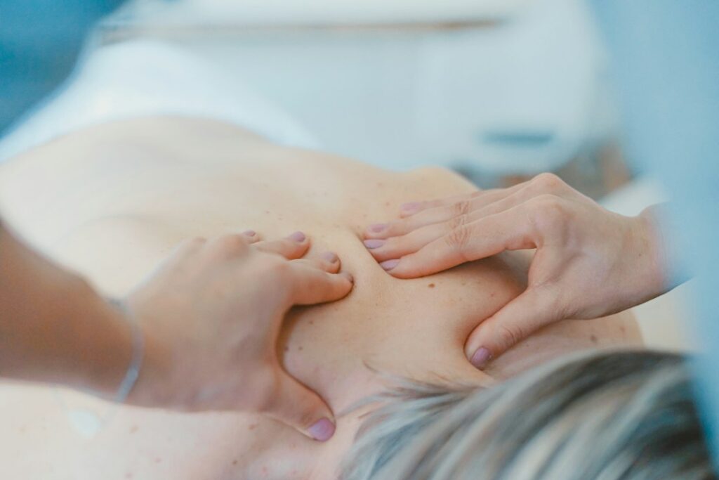 Massage therapist working on shoulder tension