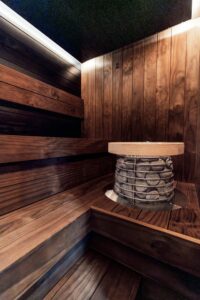 Modern wooden sauna interior with heater and benches