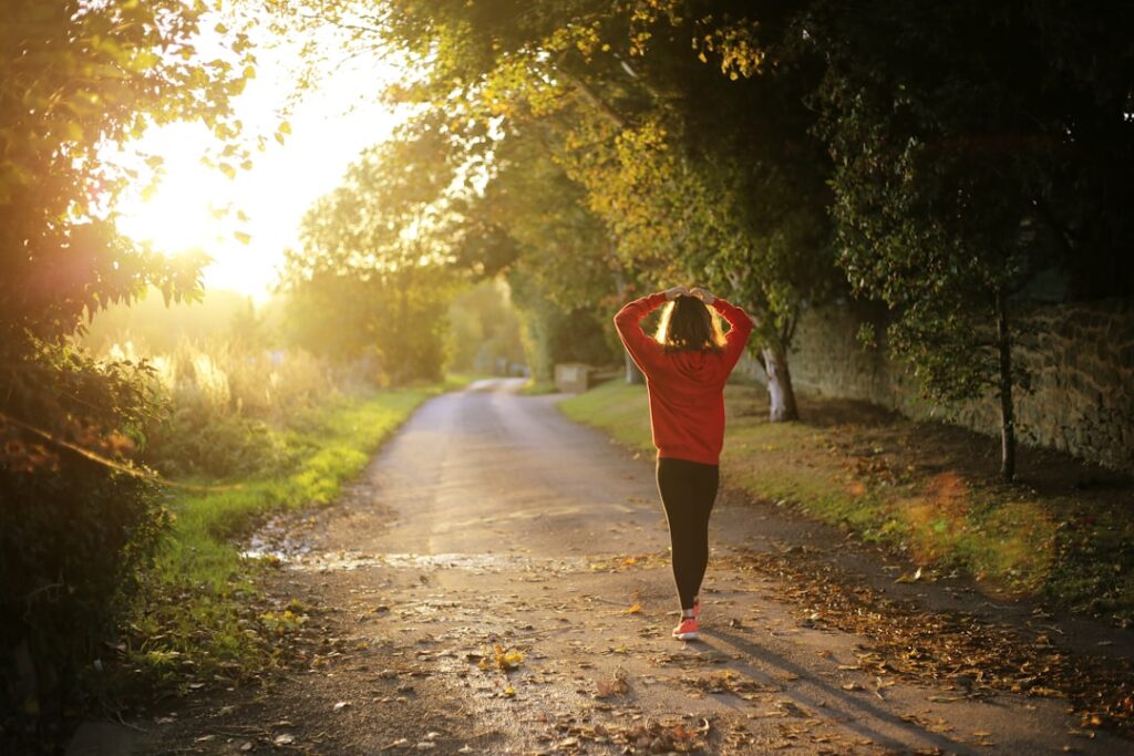 Person walking and jogging outdoors during exercise, illustrating breathlessness and walking fitness