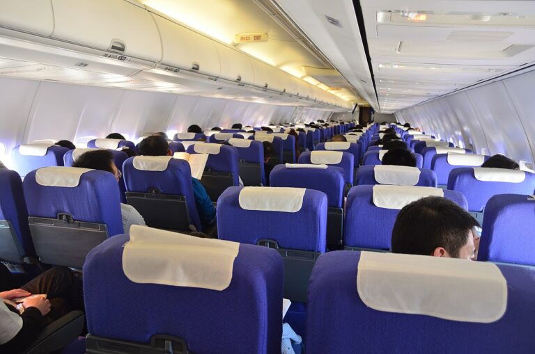 Passengers seated inside an airplane cabin during a long flight